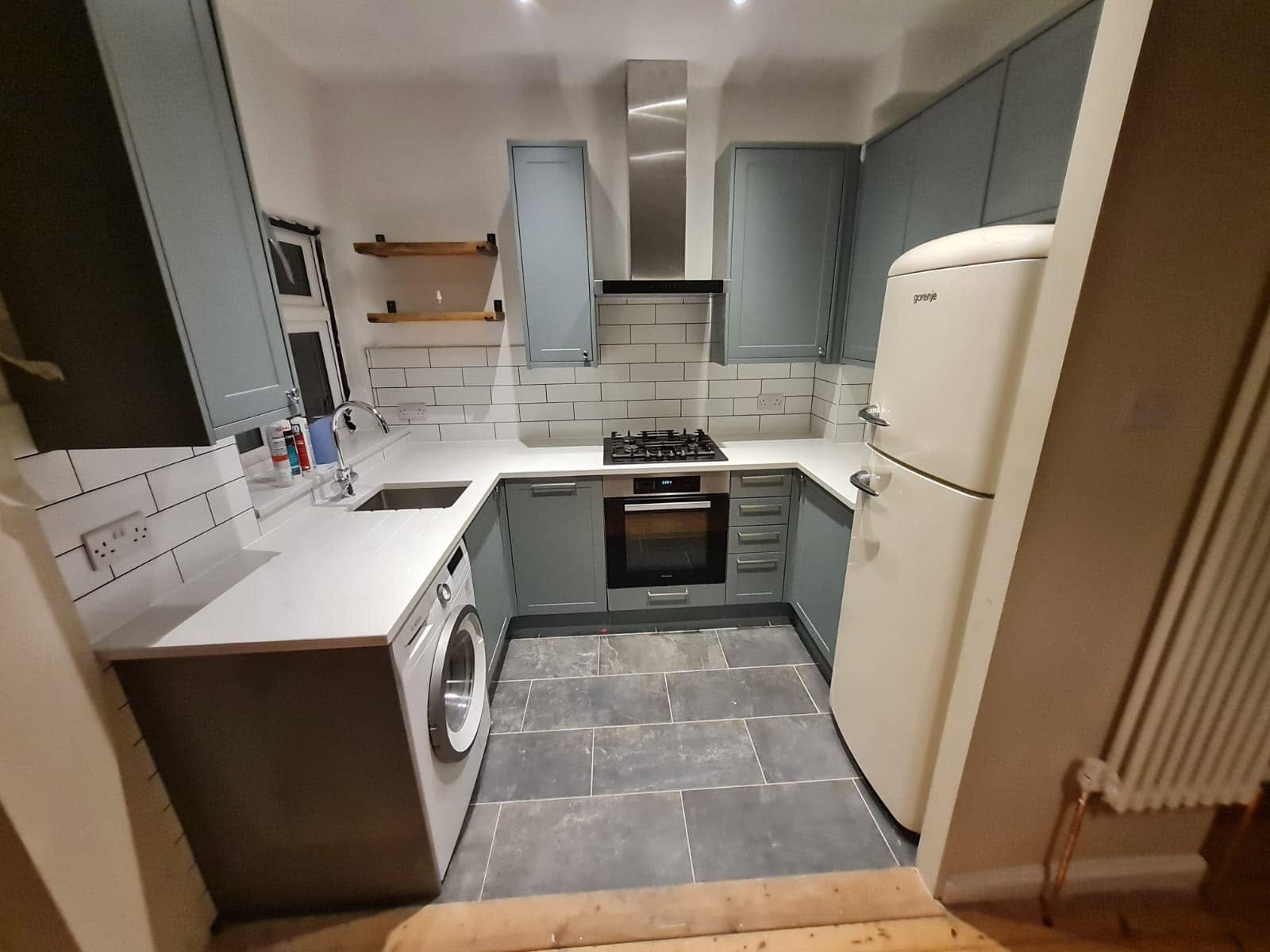 Teal shaker kitchen with timber worktops